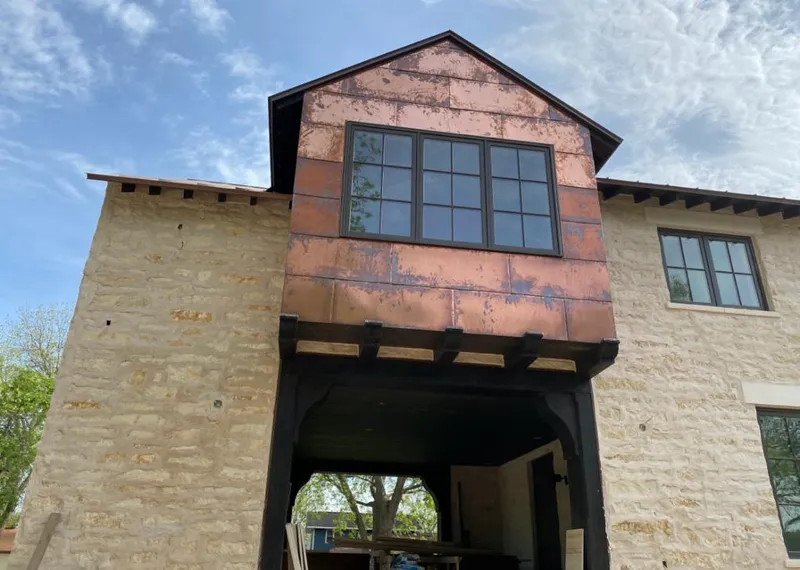 Copper metal panel facade on a stone building for Skylight Installation in Frederickson