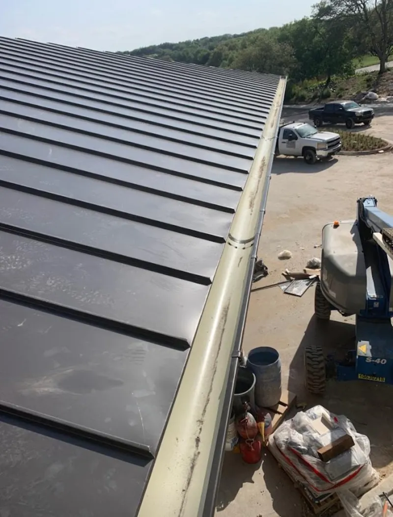 Standing seam panel and gutter detail on a metal roofing jobsite in Frederickson